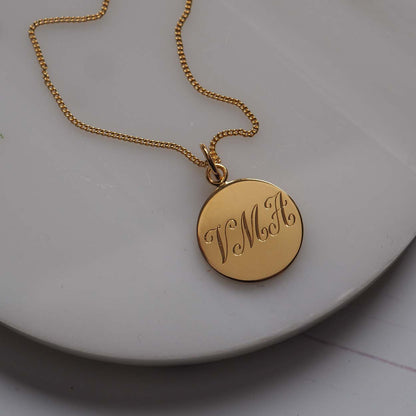 Triple Initial Necklace in Yellow Gold Vermeil, hand-engraved with three intertwined initials. A timeless keepsake representing cherished connections and love.