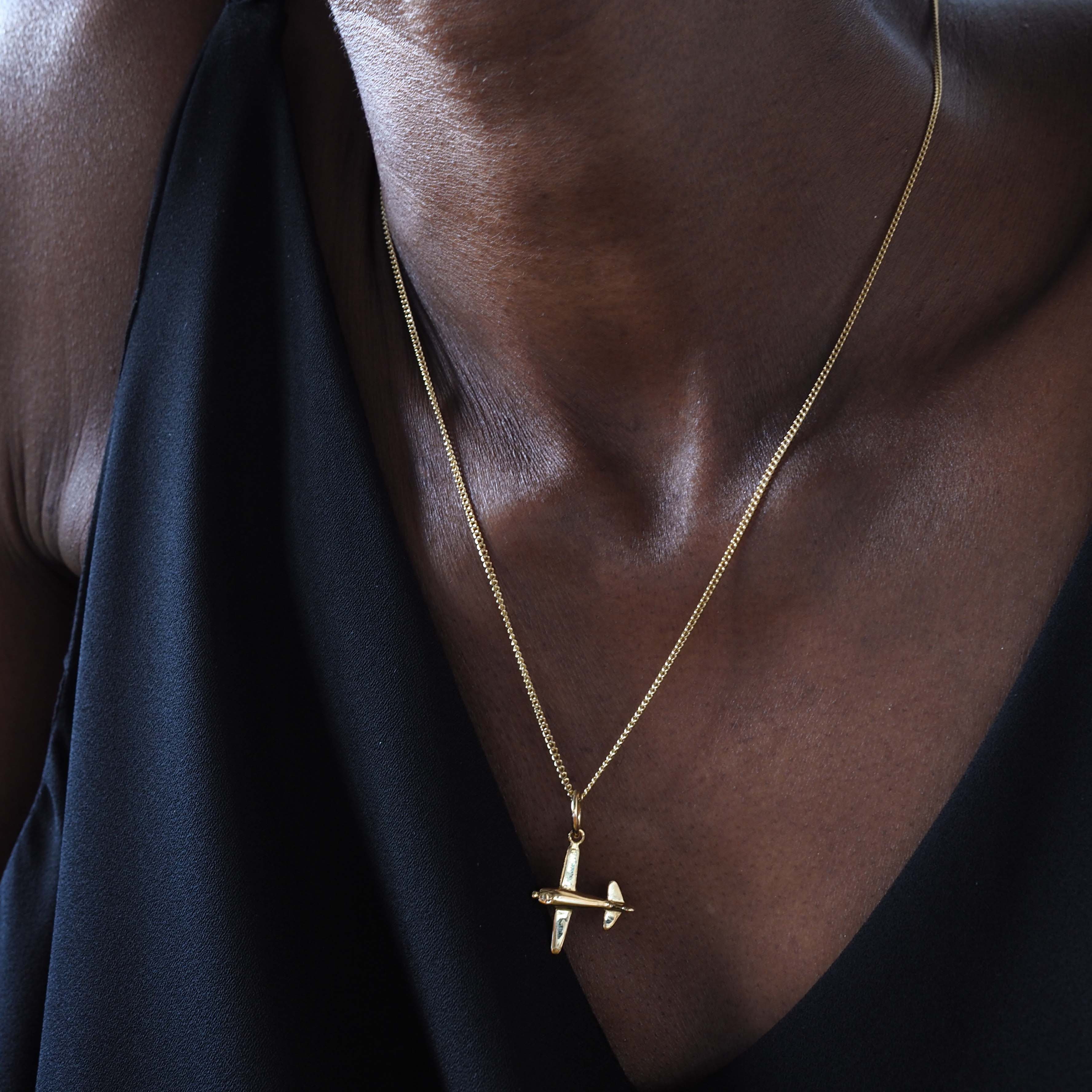 Woman wearing 18ct solid gold airplane necklace 