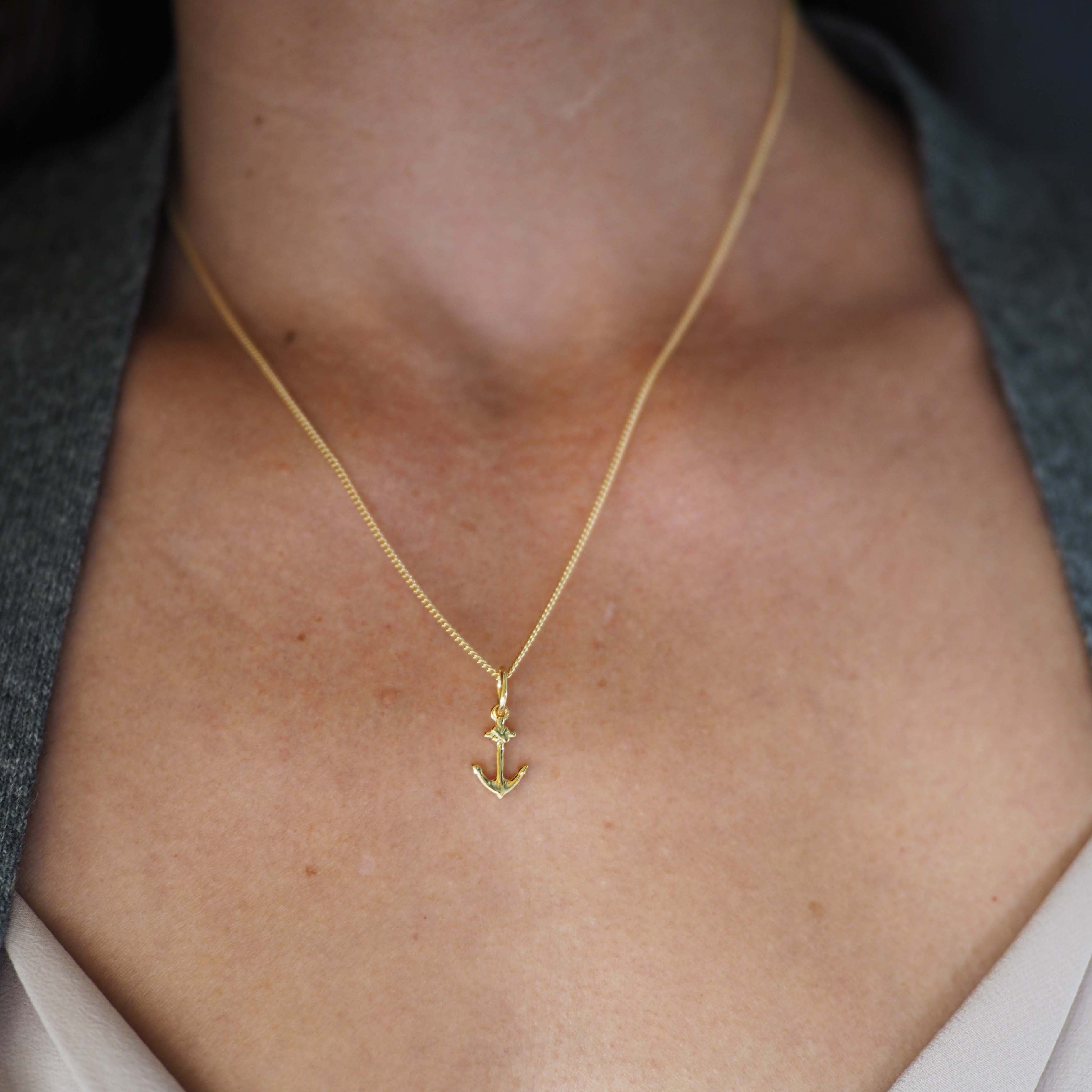 18ct gold anchor pendant necklace styled with a pink blouse 