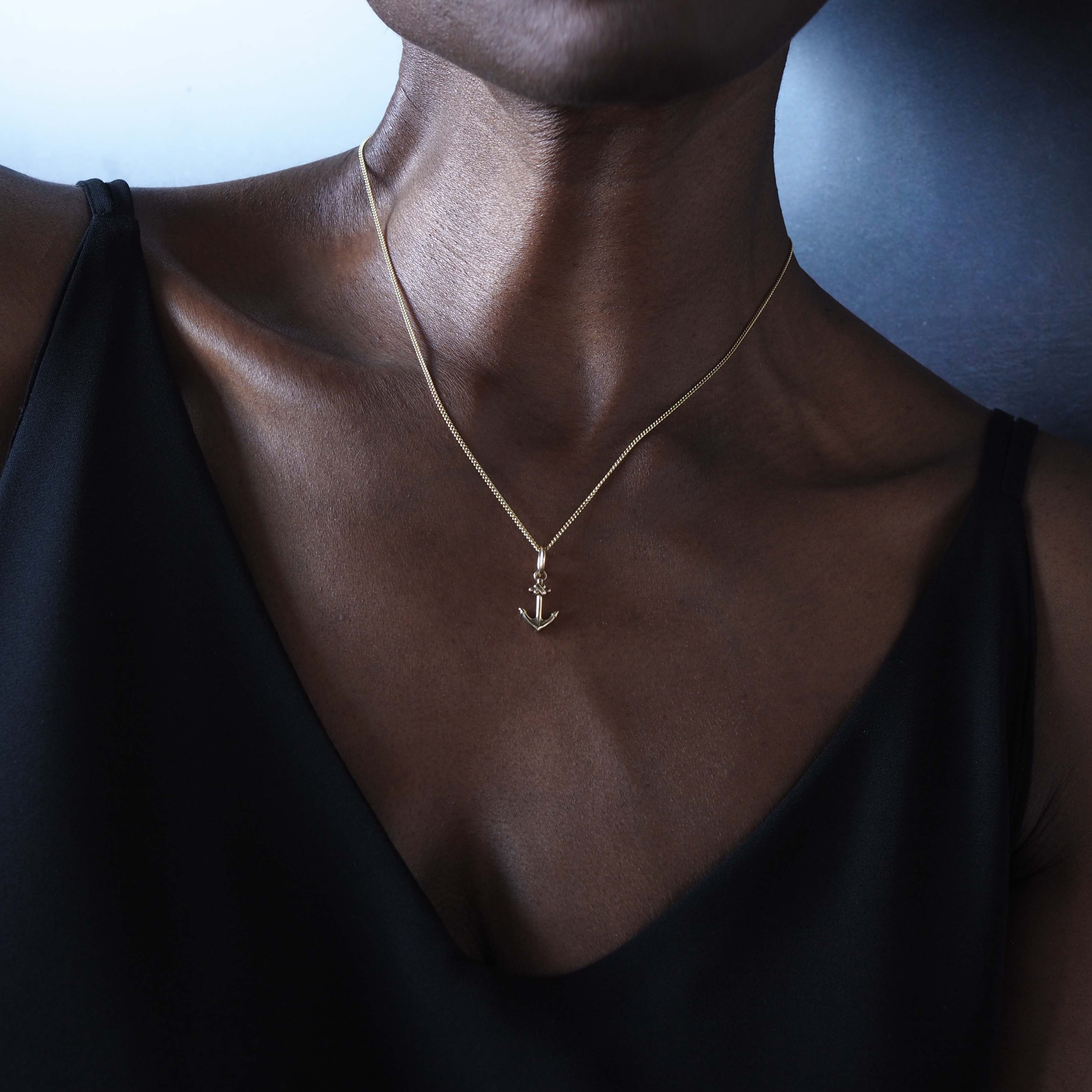 Model wearing Bianca Jones 18ct gold anchor necklace, handmade in London
