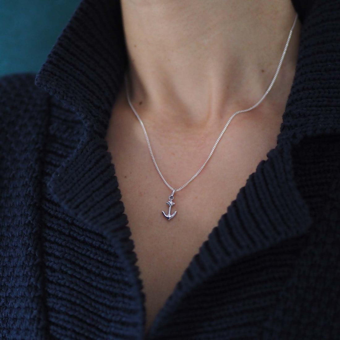 Silver anchor necklace symbolising strength and hope, handmade in London.