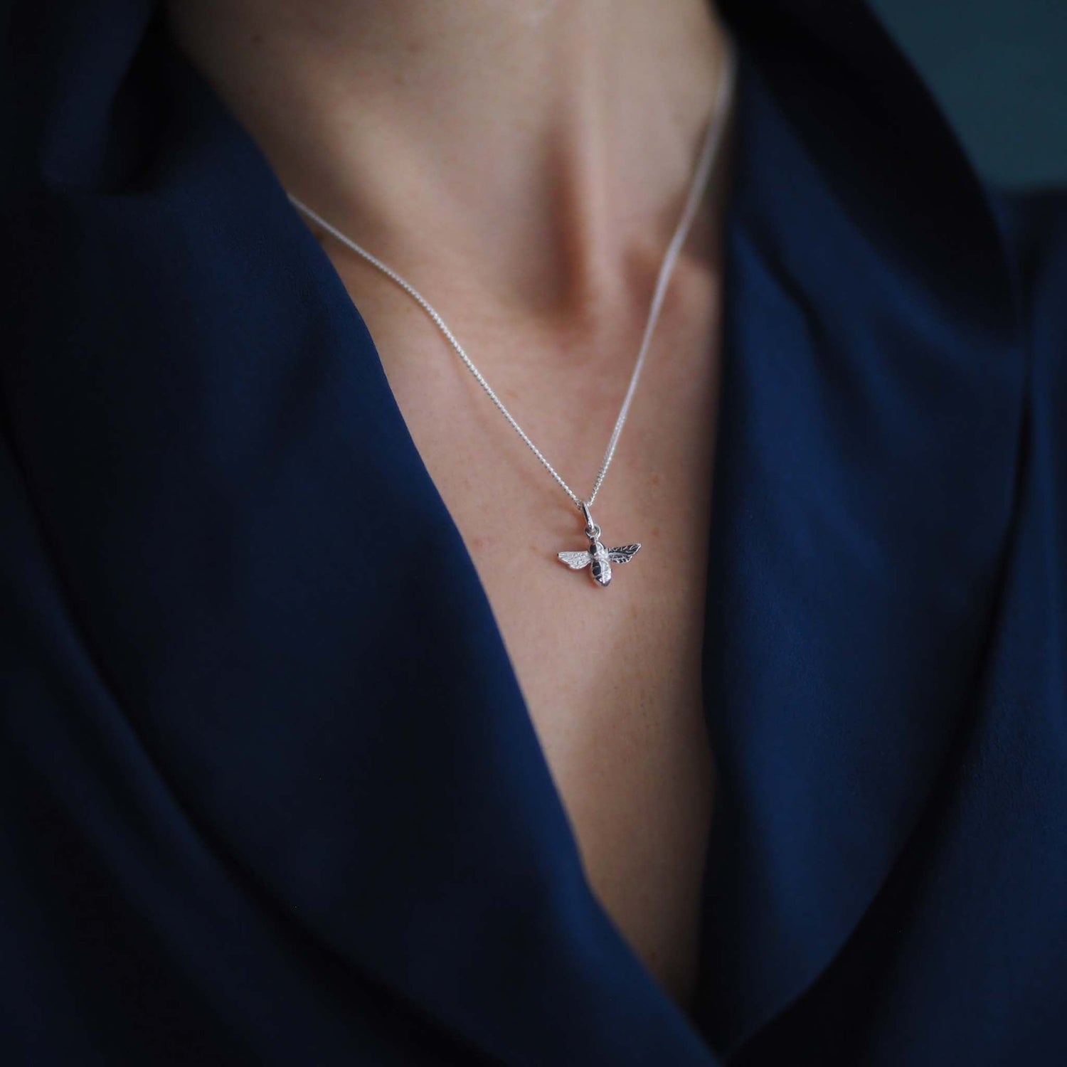 Model wearing 18ct white gold bee necklace on 18-inch chain