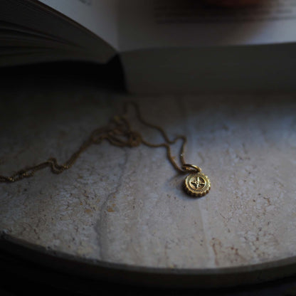 Detail of Compass Mini pendant with engraved compass design