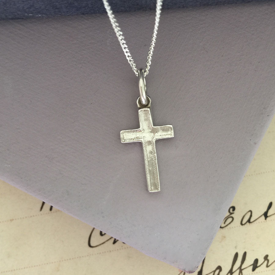 Close-up of the Solid Gold Cross Necklace with handcrafted texture and sculptural design