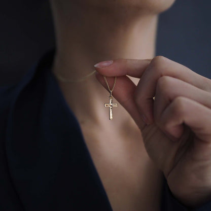 Woman wearing the Solid Gold Cross Necklace, a modern heirloom symbol of faith and love