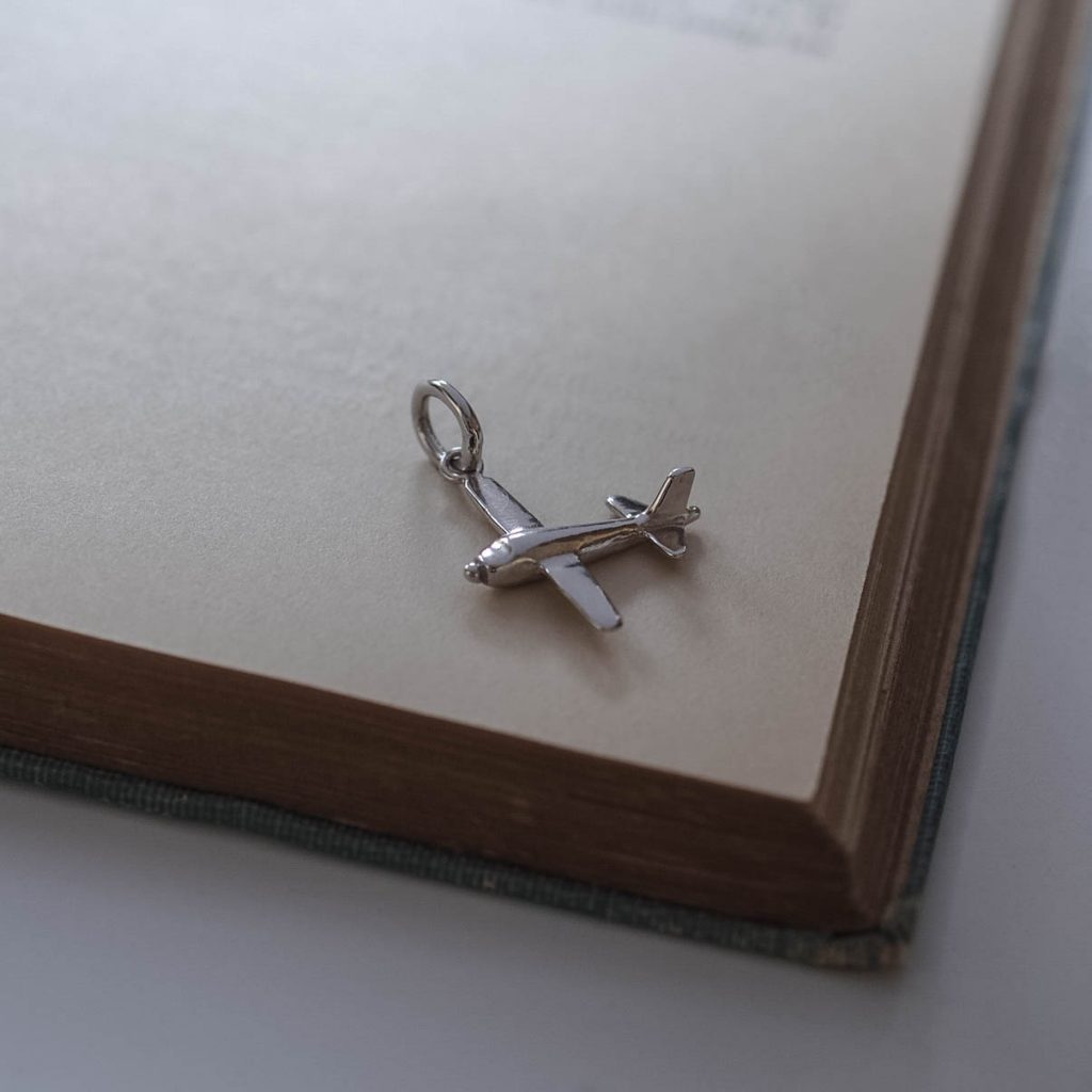 Handmade solid gold aeroplane charm, available in white, rose, and yellow gold, capturing fine craftsmanship with detailed design