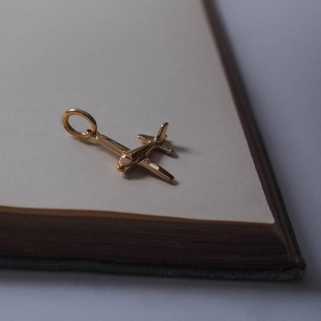 Handmade solid gold aeroplane charm, available in white, rose, and yellow gold, capturing fine craftsmanship with detailed design