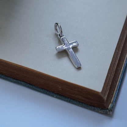 Bianca Jones handmade solid gold cross charm with intricate detailing along the edge, available in white, rose, and yellow gold