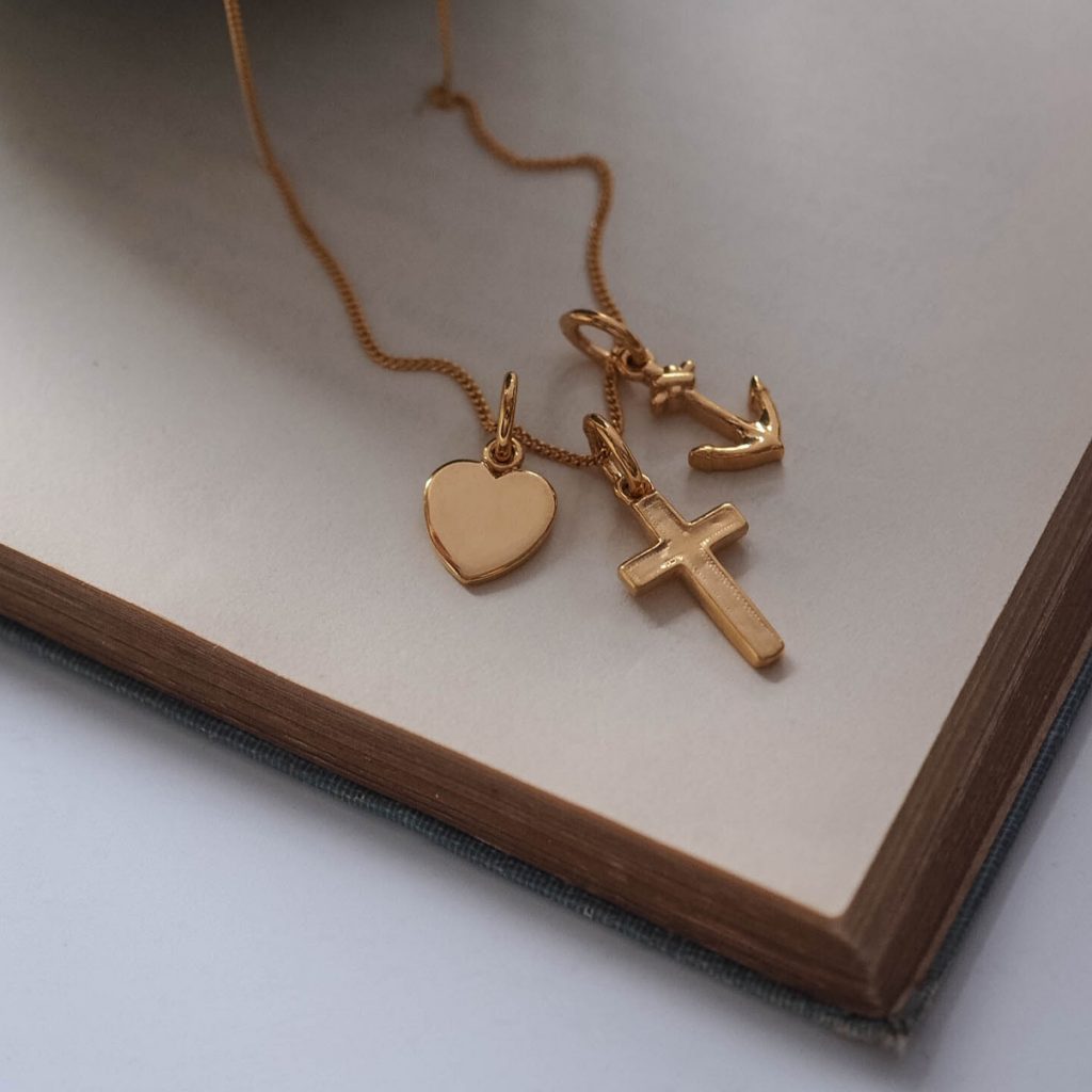 Faith, Hope, and Charity Necklace with heart, anchor, and cross symbols, intricately designed to represent love, hope, and protection.