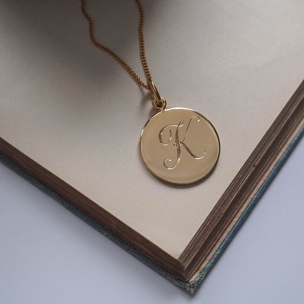 Gold Vermeil Initial Necklace with a hand-engraved scrolled initial, symbolising love and cherished connections. Inspired by Victorian love tokens.