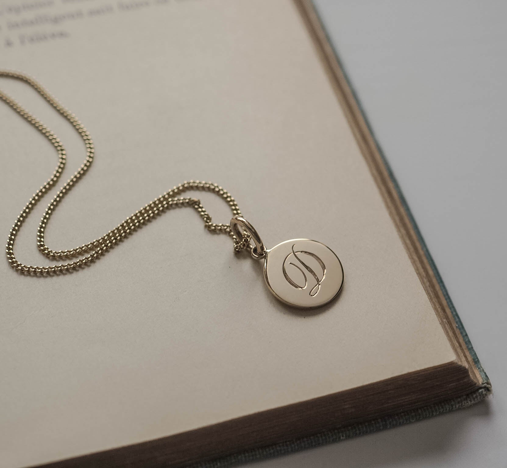 Initial Mini Necklace in Solid Gold with a hand-engraved scrolled initial, available in yellow, rose, or white gold. A delicate piece for personal storytelling and meaningful gifting.