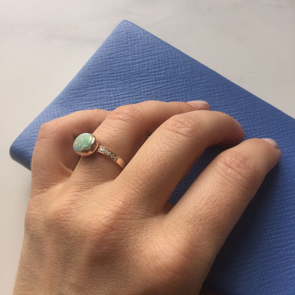 Bianca Jones bespoke opal rose gold ring with diamonds, radiating a blend of timeless romance and luxury.