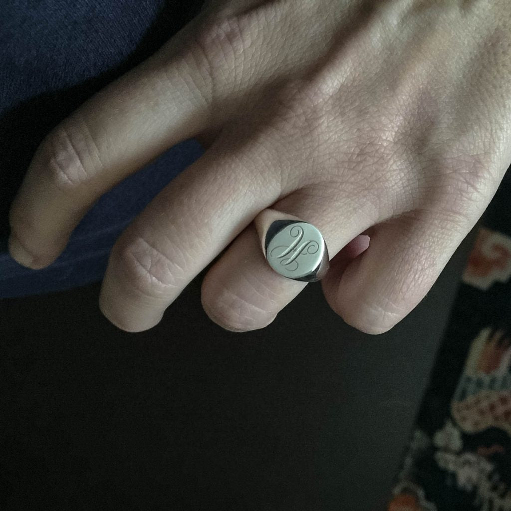 handmade sterling silver plain oval signet ring, highlighting its sleek design and craftsmanship.