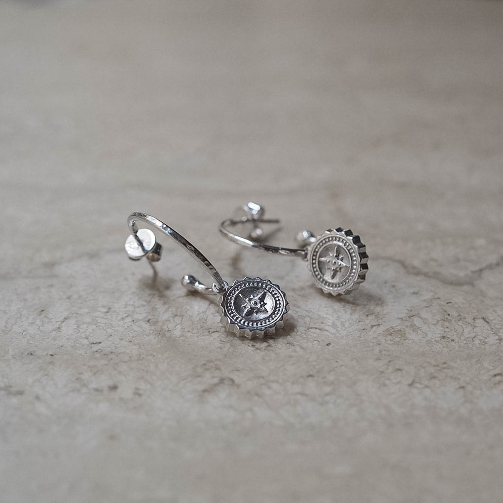 Solid gold Compass Hoop Earrings in yellow, white, or rose gold with removable engraved compass charm — handmade in London.