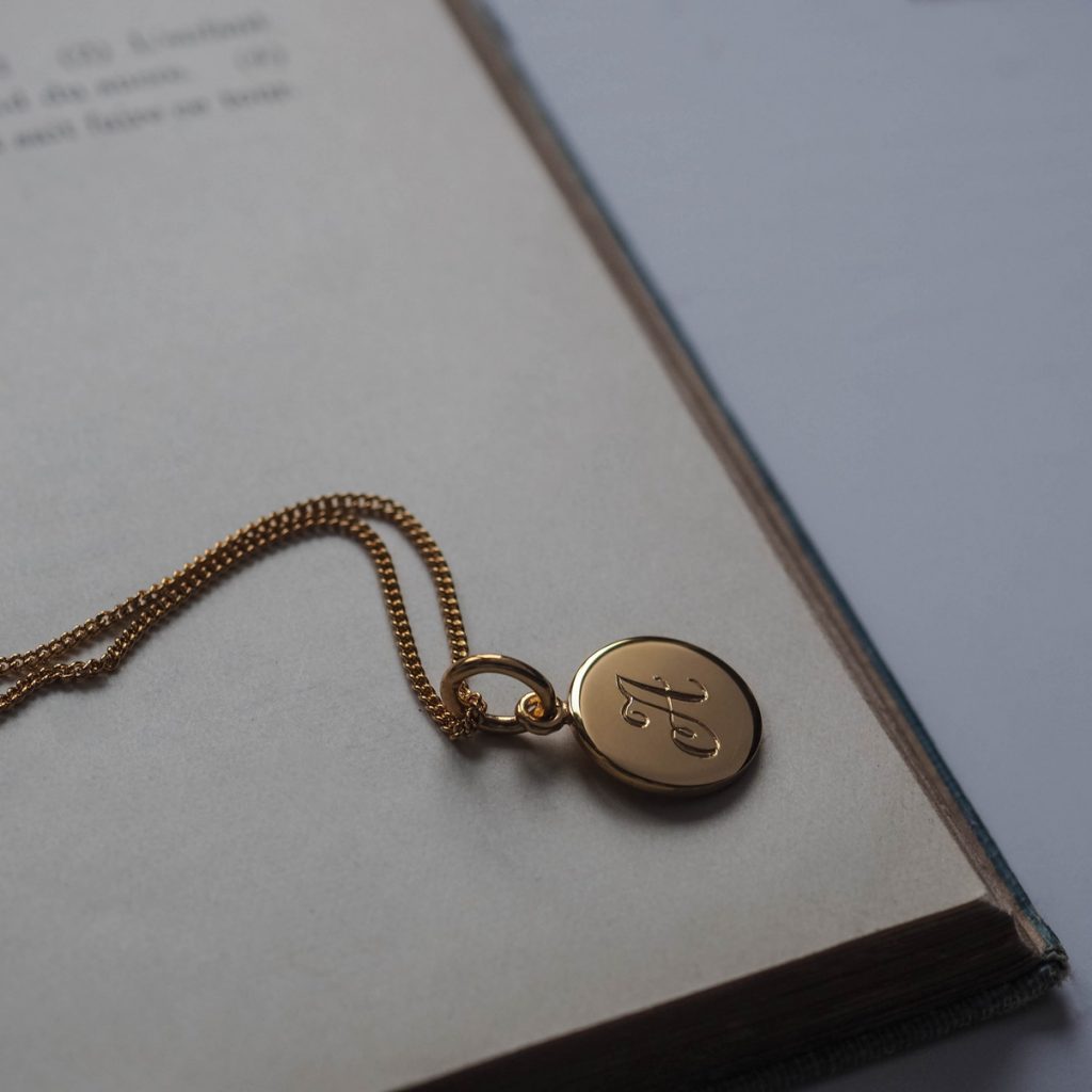 Initial Mini Necklace with a hand-engraved scrolled initial, perfect for layering or wearing alone. A personalised piece symbolising love and connection.