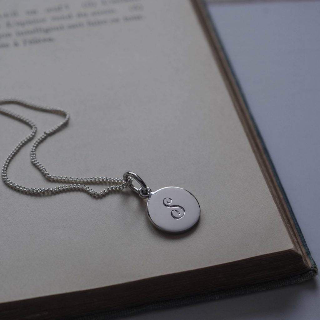 Initial Mini Necklace with a hand-engraved scrolled initial, perfect for layering or wearing alone. A personalised piece symbolising love and connection.