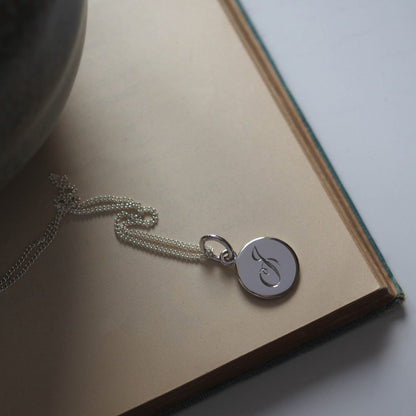 Initial Mini Necklace with a hand-engraved scrolled initial, perfect for layering or wearing alone. A personalised piece symbolising love and connection.