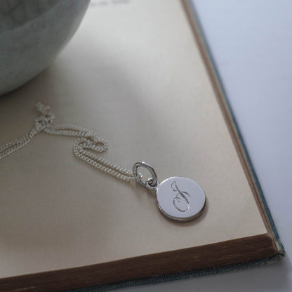 Initial Mini Necklace with a hand-engraved scrolled initial, perfect for layering or wearing alone. A personalised piece symbolising love and connection.